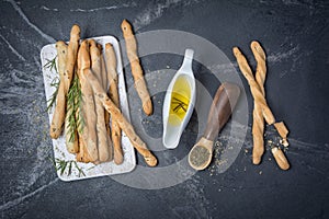 Top view of traditional italian appetizer grissini with rosemary spice and olive oil