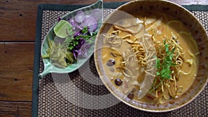Top View of Traditional Lanna Style Dish - Khao Soi Soup with Crispy Noodles. Authentic Nothern Thai Cuisine