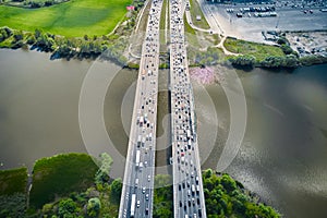 Top view on traffic on the straight bridge over water. Parallel separate roads