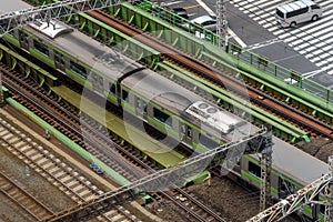 Top view train running and railway track on elevated rails over the road. At Tokyo city, Japan