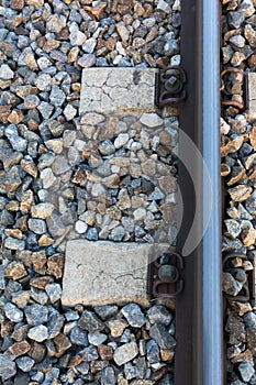 Top view of train tracks surrounded by rocks at daytime