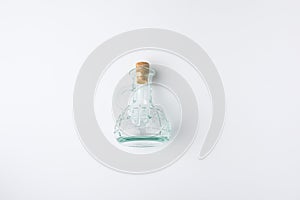 Top view of transparent blue glass bottle with cork