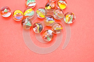 Top view of transparent glass balls on a pink background