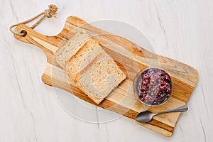 Pot with cherry jam and toast bread