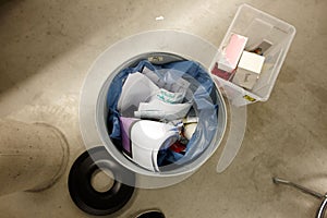 Top view of a trash can full of paper