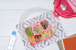 top view of tray with kids lunch for school and copybooks