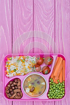 top view of tray with kids lunch for school on violet