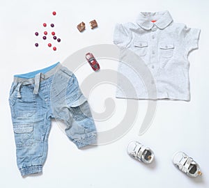 top view trendy denim look of baby boy clothes with toy and ssweets