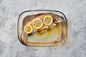 Top view of trout baked in oven in glass baking dish