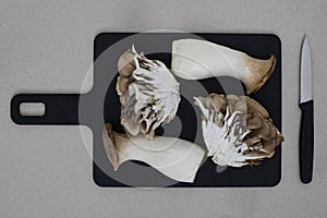 Mushrooms on the black cutting board