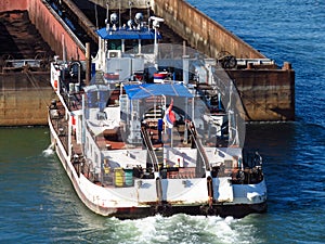 Top view of Tugboat pushing a empty barge on the river