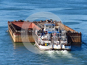 Top view of Tugboat pushing a empty barge on the river