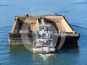 Top view of Tugboat pushing a empty barge on the river