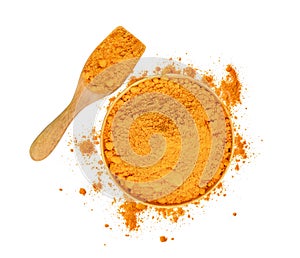 Top view of turmeric powder in wooden bowl and spoon isolated