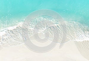 Top view of turquoise color of  wave water background on the summer beach at the seashore and  white  sand beach -Summer pattern