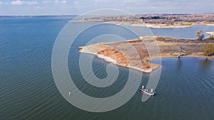 Top view two anglers fishing from motor boat at Murrell Park, Lake Grapevine, Texas, USA