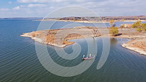 Top view two anglers fishing from motor boat at Murrell Park, Lake Grapevine, Texas, USA