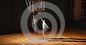 Top view of two basketball players curly dribbling night game standoff attack defence