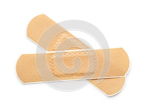 Top view of two beige adhesive bandages