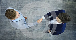 Top view of a two businessman shaking hands. Welcome to business.