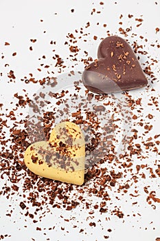 Top view of two chocolate hearts on a white background, flat lay, close-up
