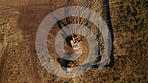 Top view of two excavators doing earthwork at construction site