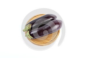 Top view of two fresh eggplants on a wooden plate isolated on a white background