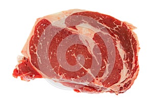 Top view of two fresh ribeye steaks atop one another on a white background