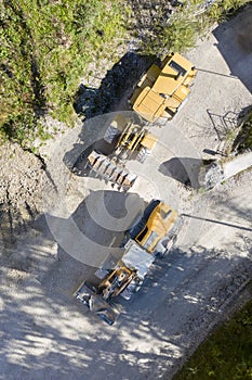 Top view of two orange wheel-mounted front loader