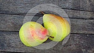 Top view. Two Organic Yellow Pear Fruits. Natural Pear Harvest on Wood Texture Background.