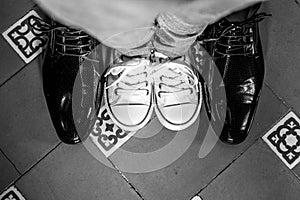 Top view of two pairs of shoes in grayscale