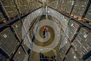 Top view of two people in megastore with lots of containers on the shelves