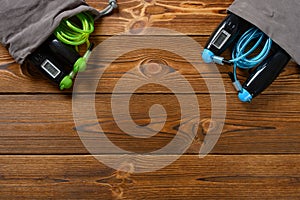 Top view two sets skipping ropes with digital counters on wood background