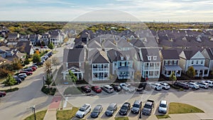 Top view two-story upscale cottage style houses with downtown Dallas in the distance, Texas