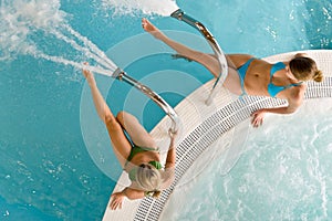 Top view - two woman relax in swimming pool