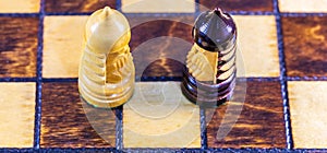 Top view of two wooden chess figures pieces on a chessboard