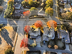 Top view typical park side houses with light snow covered roof in cold fall morning
