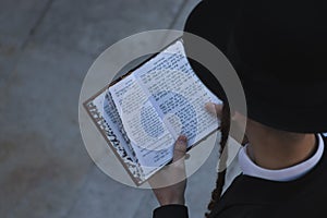 A top view of an ultra-Orthodox Jewish man praying during the morning prayer service at the Western Wall