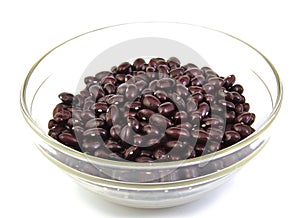 Top view of uncoocked red beans on a cristal bowl
