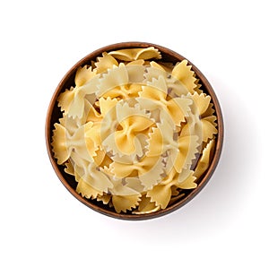 Top view of uncooked farfalle pasta in clay bowl