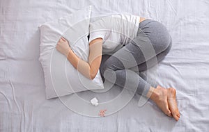 Top view of unhappy woman suffering from sleep deprivation or depression, committing suicide, having mental problem