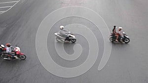Top view of unidentified people on motorbikes passing by, isolated on tamrac, asphalt