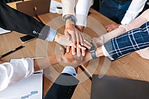 Top-View Of United Business Team Holding Hands In Office