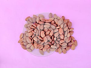 Top view of unpeeled heap of almonds