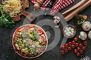 Top view of unprepared pizza with ingredients