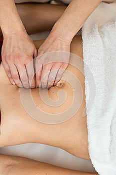 Hands of physiotherapist checking diastasis recti on belly of postpartum woman photo