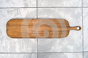 Top view of unused new handmade brown wooden cutting board