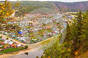 Top view of the Ural village STAROSUBHANGULOVO surrounded by the river Belaya among mountain peaks and taiga.