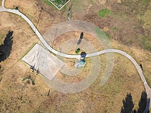 Top view urban park with curved pathway and volleyball, basketball fields