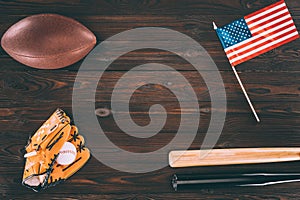 top view of us flag, rugby ball, baseball bats and glove with ball